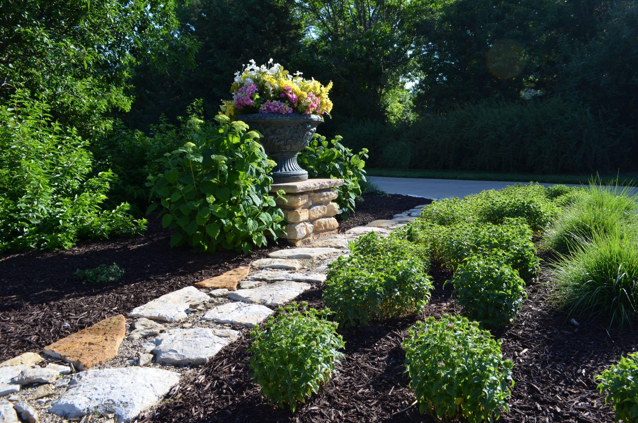 Garden bed with stone path and planter
