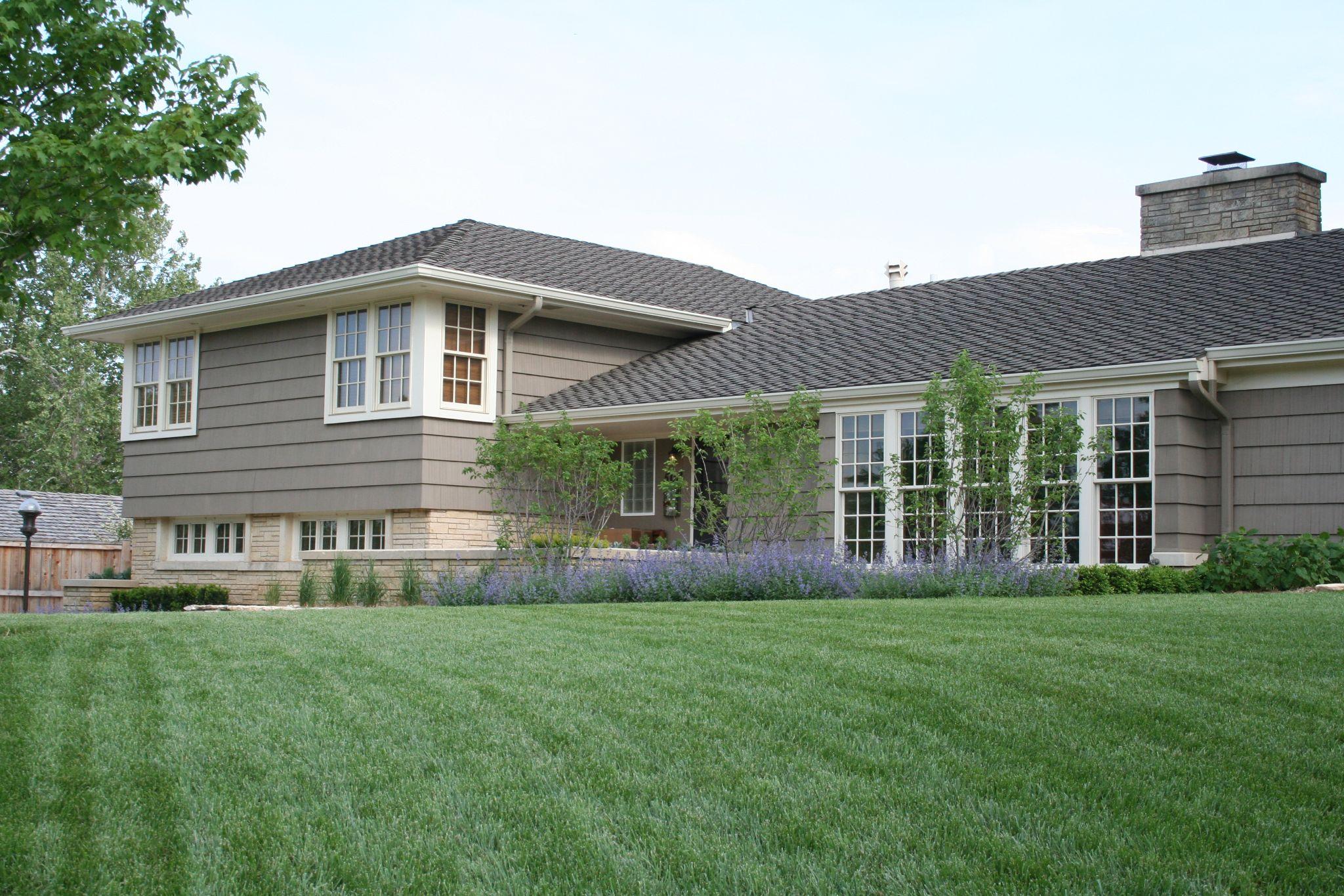House with manicured front lawn and shrubs